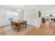 Dining room with traditional wainscoting, a view to the living room, and large windows at 367 Kennerly Center Dr, Mooresville, NC 28115