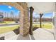 Charming front porch featuring stone archway and wooden columns, creating a welcoming entrance at 367 Kennerly Center Dr, Mooresville, NC 28115