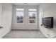 This bedroom features plush carpet and two large windows for lots of natural light at 3750 Ellington St, Charlotte, NC 28211