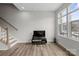 Bright living area featuring stairs, television, and a large window at 3750 Ellington St, Charlotte, NC 28211