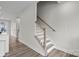 Clean white staircase with wooden handrail at 3750 Ellington St, Charlotte, NC 28211