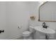 Clean half-bathroom featuring a toilet and an elegant pedestal sink, with a decorative wall mirror at 4119 Flint Dr, Lancaster, SC 29720