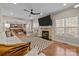 Open-concept living room with a fireplace and a view into the modern, updated kitchen at 4119 Flint Dr, Lancaster, SC 29720