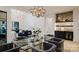 Bright dining room with a modern glass table and a view into a living room with stylish furnishings at 412 Bertonley Ave, Charlotte, NC 28211