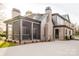 Charming exterior view of home showcasing the screened-in porch, brick chimney, and modern design at 412 Bertonley Ave, Charlotte, NC 28211