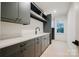 Modern laundry room with gray cabinetry, ample counter space, and natural light at 412 Bertonley Ave, Charlotte, NC 28211