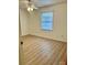 Bedroom featuring wood-look floors, neutral walls, and a window at 4520 Central Ave # C, Charlotte, NC 28205