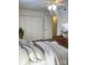 Comfortable bedroom featuring a ceiling fan, closet, and well-lit space with light walls, wood floors, and cozy decor at 4520 Central Ave # C, Charlotte, NC 28205