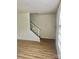 Neutral Living room featuring modern flooring, staircase with handrail, and ample lighting at 4520 Central Ave # C, Charlotte, NC 28205