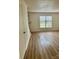 Spacious living room with modern flooring, large window offering natural light, and neutral walls at 4520 Central Ave # C, Charlotte, NC 28205