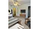 Comfortable main bedroom featuring a ceiling fan, decorative rug, and a mounted television at 4520 Central Ave # C, Charlotte, NC 28205