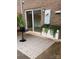 Outdoor patio area featuring a modern rug, table, and seating, complemented by greenery and privacy at 4520 Central Ave # C, Charlotte, NC 28205