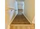 Carpeted staircase leading to the upper level, creating a smooth flow within the home at 4520 Central Ave # C, Charlotte, NC 28205