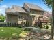 Large brick home featuring a wooden deck, stone patio, and well-manicured lawn and landscaped backyard at 4708 Pearmain Dr, Waxhaw, NC 28173