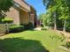 Spacious backyard with a brick patio, upper level deck, brick facade, green lawn, and tasteful landscaping at 4708 Pearmain Dr, Waxhaw, NC 28173