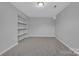 This cozy bedroom features neutral carpeting and a built-in shelving unit for extra storage at 49 Orchard Trace Ct, Taylorsville, NC 28681