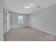 This bedroom features a large window with exterior light and neutral walls and carpet at 49 Orchard Trace Ct, Taylorsville, NC 28681