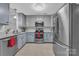 Stylish kitchen featuring stainless steel appliances and light blue cabinets at 49 Orchard Trace Ct, Taylorsville, NC 28681