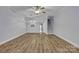 Open-concept living room featuring hardwood floors, a ceiling fan, and stairs to the second floor at 49 Orchard Trace Ct, Taylorsville, NC 28681