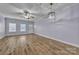 Well-lit living room with hardwood floors, a front door, and a ceiling fan at 49 Orchard Trace Ct, Taylorsville, NC 28681