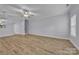 Bright living room featuring hardwood floors, a ceiling fan, and stairs to the second floor at 49 Orchard Trace Ct, Taylorsville, NC 28681