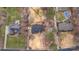 Overhead view of home with a wooden deck, surrounded by lush greenery and neighboring houses at 507 Saint Johns Dr, Salisbury, NC 28144