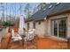 Backyard patio with outdoor dining furniture and a relaxing hot tub on a wooden deck at 507 Saint Johns Dr, Salisbury, NC 28144