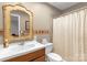 Bathroom featuring a vanity with decorative mirror, tiled walls, toilet and shower with curtain at 507 Saint Johns Dr, Salisbury, NC 28144