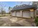 Three-car garage exterior featuring decorative doors and a paved driveway at 507 Saint Johns Dr, Salisbury, NC 28144