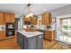 Modern kitchen with a center island, wooden cabinetry, stainless appliances and white subway tile backsplash at 507 Saint Johns Dr, Salisbury, NC 28144