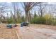 Large backyard with a concrete parking pad, mature trees, and a utility trailer at 524 W Horah St, Salisbury, NC 28144