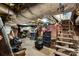 Unfinished basement with exposed ceiling insulation, concrete floor and wooden stairs at 524 W Horah St, Salisbury, NC 28144