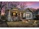 Charming home with a front porch, brick accents, and a well-manicured lawn under a beautiful dusk sky at 524 W Horah St, Salisbury, NC 28144