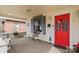 Cozy front porch with chairs, a table, and a charming red front door at 524 W Horah St, Salisbury, NC 28144