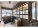 Enclosed sunroom with large windows, view of backyard, and a grill at 524 W Horah St, Salisbury, NC 28144