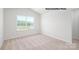 An empty bedroom bathed in natural light showcases neutral carpet at 529 Trading Post Ln, York, SC 29745