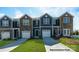 New townhomes with stone accents, attached garages and manicured lawns at 529 Trading Post Ln, York, SC 29745