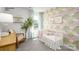 Charming Bedroom featuring a white crib, patterned wallpaper, and a rocking chair for a cozy, inviting space at 531 Trading Post Ln, York, SC 29745