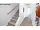 Carpeted staircase with wooden handrail and a bright, airy landing at 531 Trading Post Ln, York, SC 29745