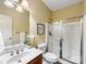 Clean bathroom with glass shower door, well-maintained tile, and plenty of natural light at 5501 Two Iron Dr, Matthews, NC 28104