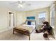 Cozy bedroom with a ceiling fan, window, and a large teddy bear for a comforting touch at 5501 Two Iron Dr, Matthews, NC 28104