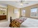 Bedroom featuring two large windows, neutral walls, ceiling fan, and ensuite bathroom at 5501 Two Iron Dr, Matthews, NC 28104