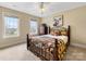 Cozy bedroom with two bright windows, ceiling fan, and Southwestern-themed decor at 5501 Two Iron Dr, Matthews, NC 28104