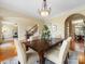 Well-lit dining room featuring a wood table, soft-toned chairs, and a view into the office space at 5501 Two Iron Dr, Matthews, NC 28104