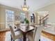 Elegant dining room with a wooden table, upholstered chairs, and a decorative chandelier at 5501 Two Iron Dr, Matthews, NC 28104