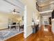 Open hallway leads to a bright home office featuring hardwood floors and a glimpse of the living area at 5501 Two Iron Dr, Matthews, NC 28104