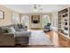 Inviting living room with a cozy sectional, built-in shelving, and lots of natural light at 5501 Two Iron Dr, Matthews, NC 28104