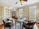 Bright home office with French doors, a glass-top desk, leather chairs, and natural light at 5501 Two Iron Dr, Matthews, NC 28104