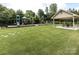 Community playground featuring play equipment and a picnic shelter with tables and seating at 5501 Two Iron Dr, Matthews, NC 28104