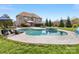 Beautiful backyard featuring a gunite pool and hot tub surrounded by a stone patio and lush landscaping at 5501 Two Iron Dr, Matthews, NC 28104